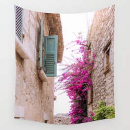 French alley full of flowers | European architecture houses, light bricks and blue shutters | Travel photography in France, South Europe Wall Tapestry