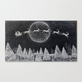 Santa flying over a winter wonderland of snow covered trees in his reindeer drawn sleigh by the light of a full moon Canvas Print