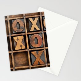 tic-tac-toe or noughts and crosses game - vintage letterpress ing block X and O in wooden grunge typesetter box with dividers Stationery Card