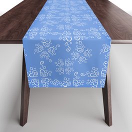 White small ornament on blue background Table Runner