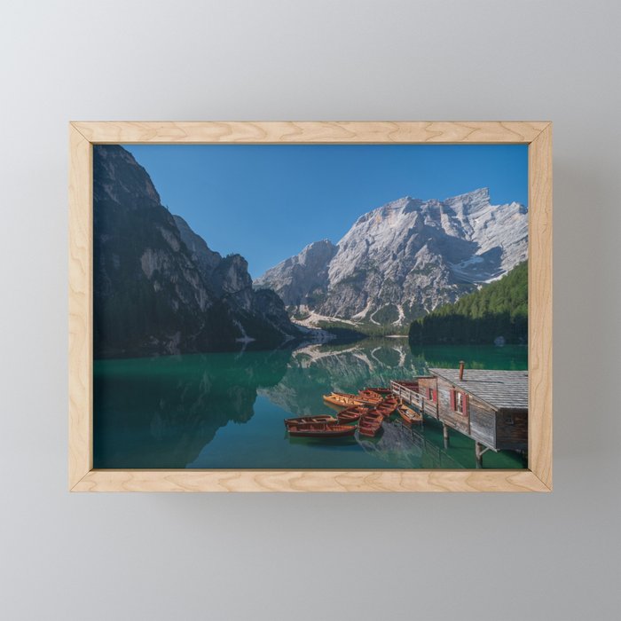 The Seekofel mountains and wooden boats reflected in the waters of Lake Braies Framed Mini Art Print