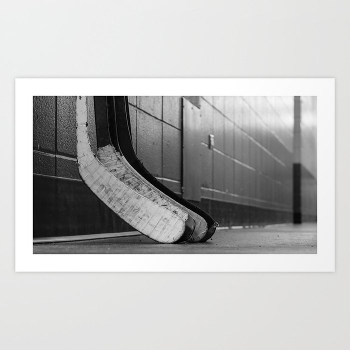 Black and white macro shot of hockey stick blades laid on a dirty arena floor Art Print