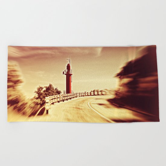 Lighthouse on the road Beach Towel