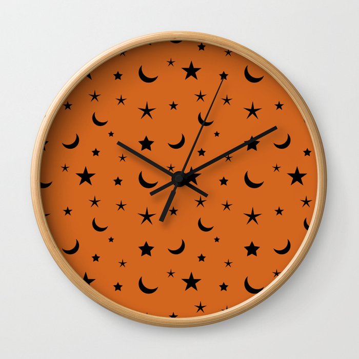 Black moon and star pattern on orange background Wall Clock
