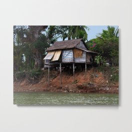 Picturesque Stilt house on the Mekong River Bank, Laos Metal Print