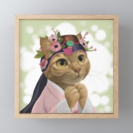 A cat wearing an 'ayam' Framed Mini Art Print