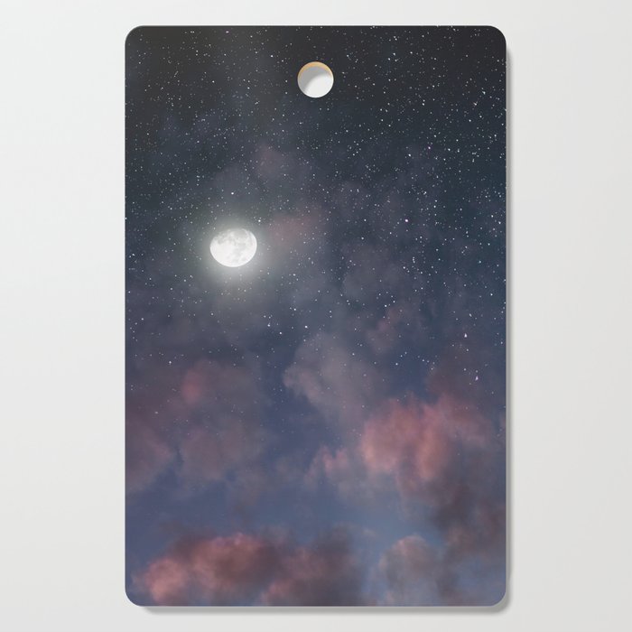 Glowing Moon on the night sky through pink clouds Cutting Board