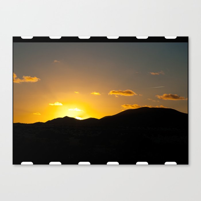Color photo of mountain sunset with film strip decoretion Canvas Print